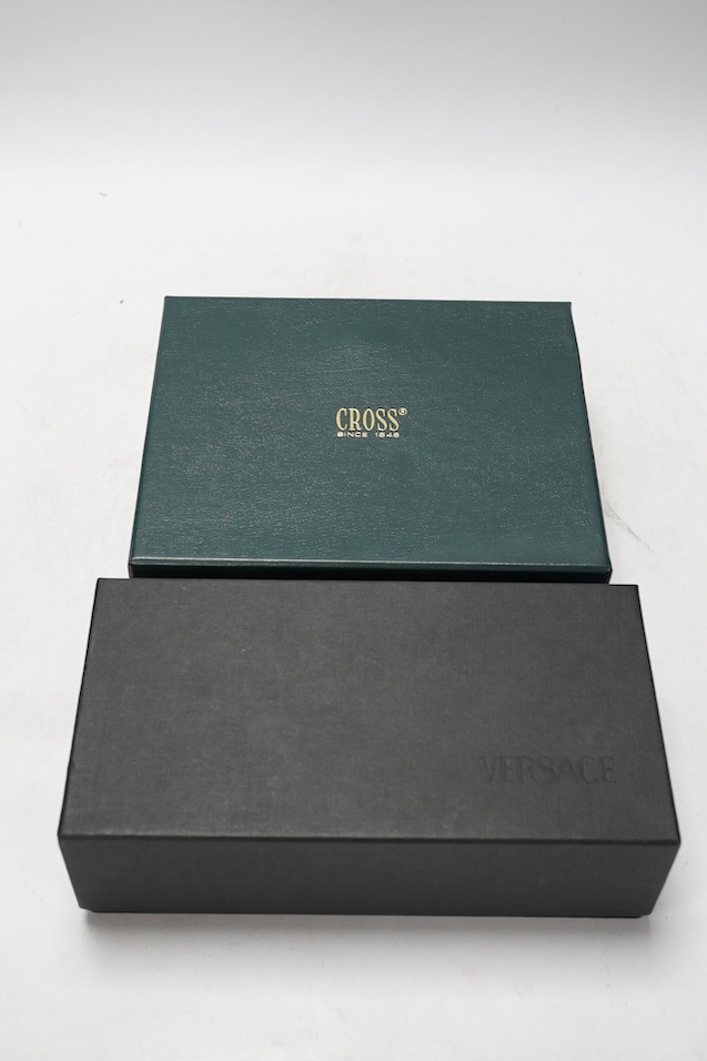 Two boxed pens; a Versace and a Cross, both with outer cardboard boxes. Condition - Versace pen good, display box good, outer box damaged. Cross pen good, ink bottle good, case damaged